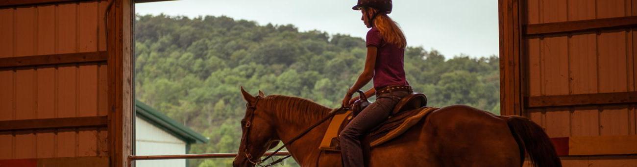 Student riding horse