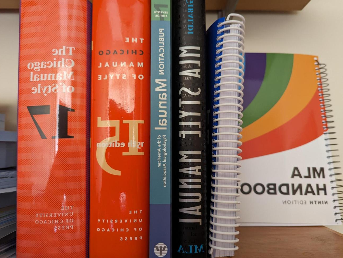 A small stack of books on a bookshelf